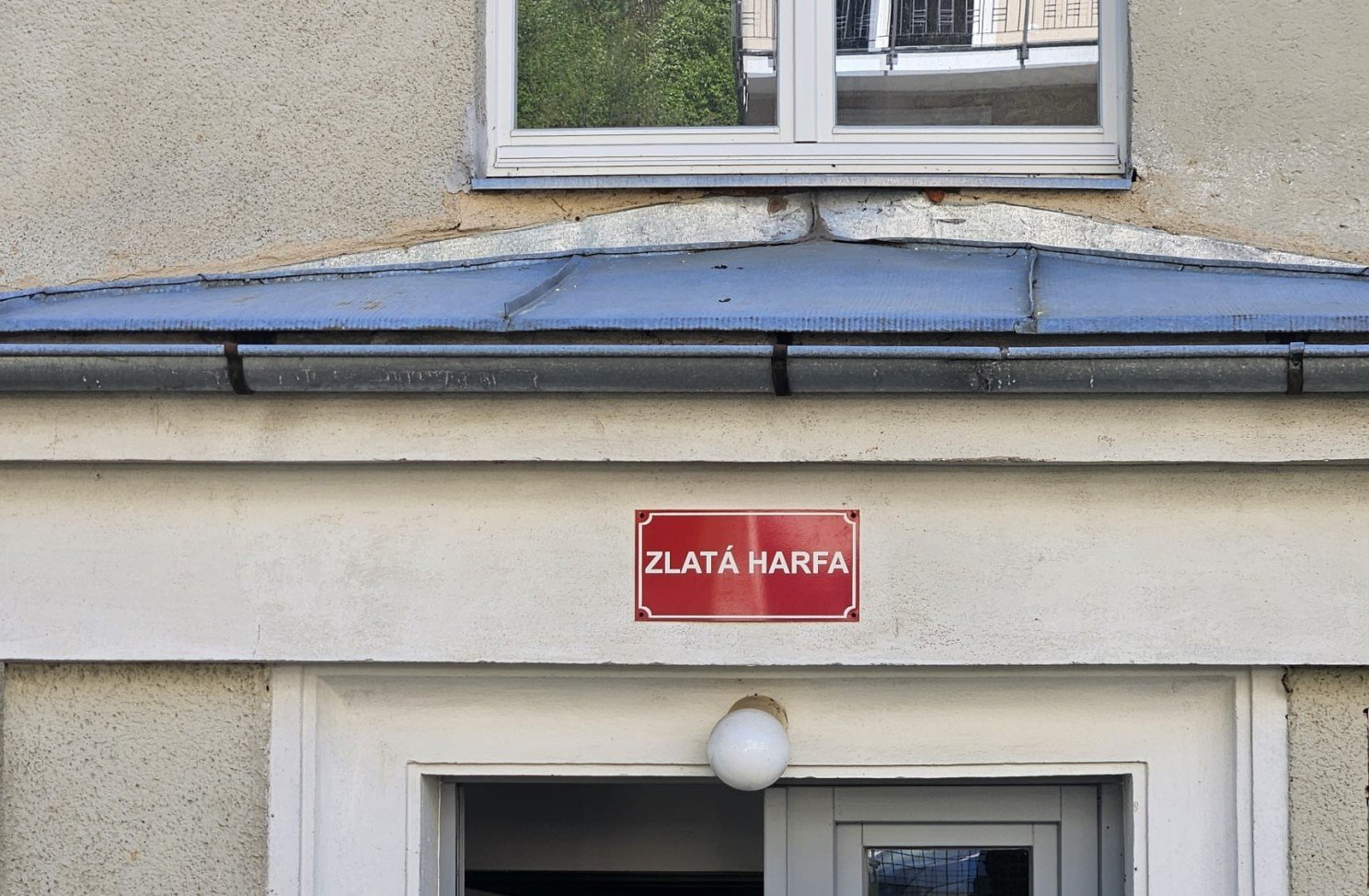 The Golden Harp sign above the entrance of the house