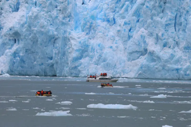 The face of the San Rafael Glacier with small boats below