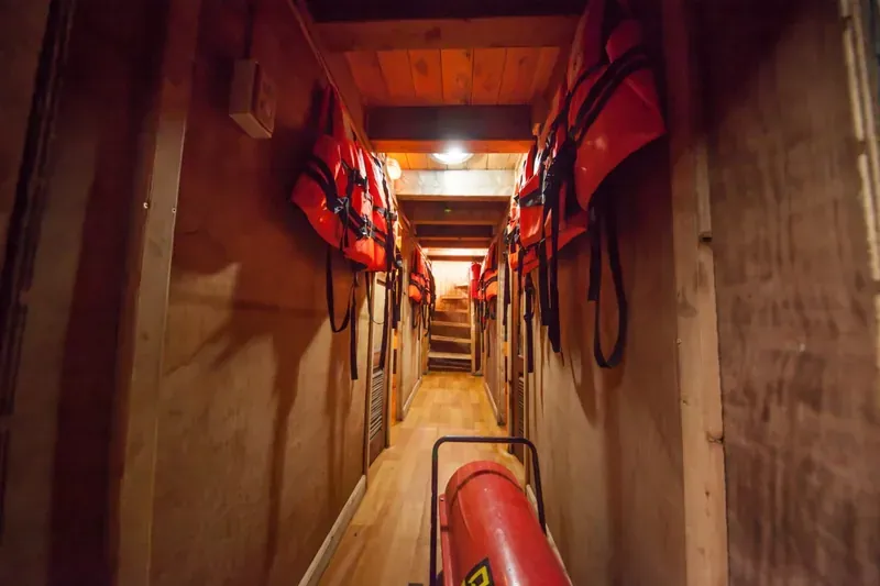 Corridor between the cabins on Patagonia I, with life jackets hanging on both walls